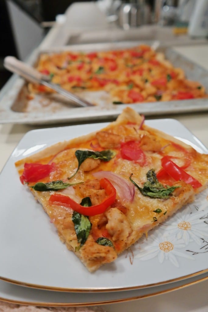 Pizza with chicken and baby spinach