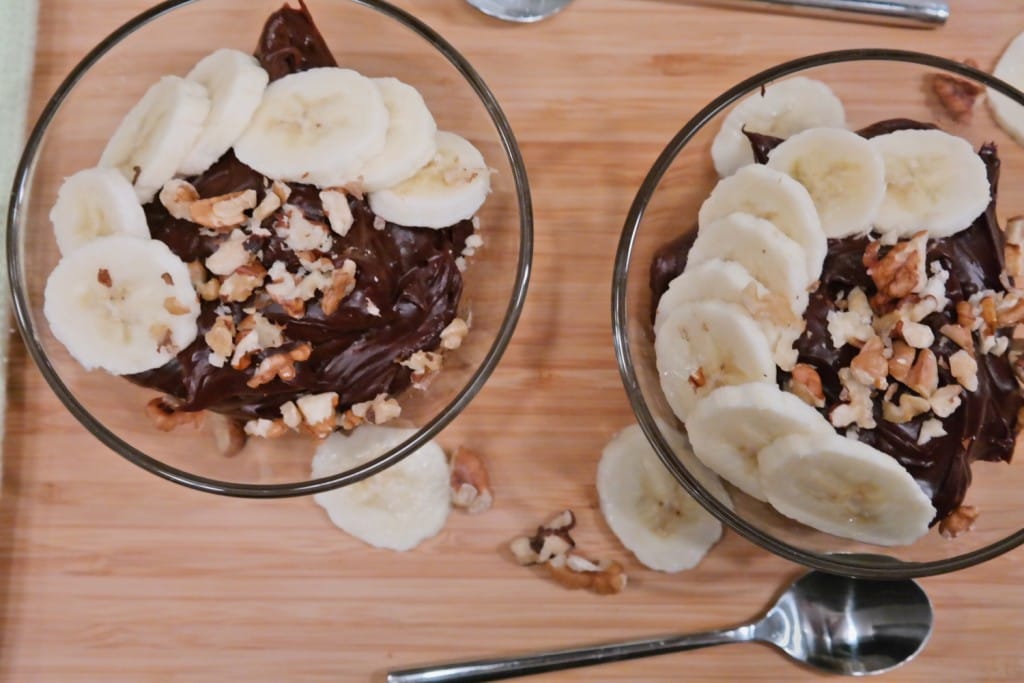 Chocolate and peanut butter pudding with nuts and banana on the side