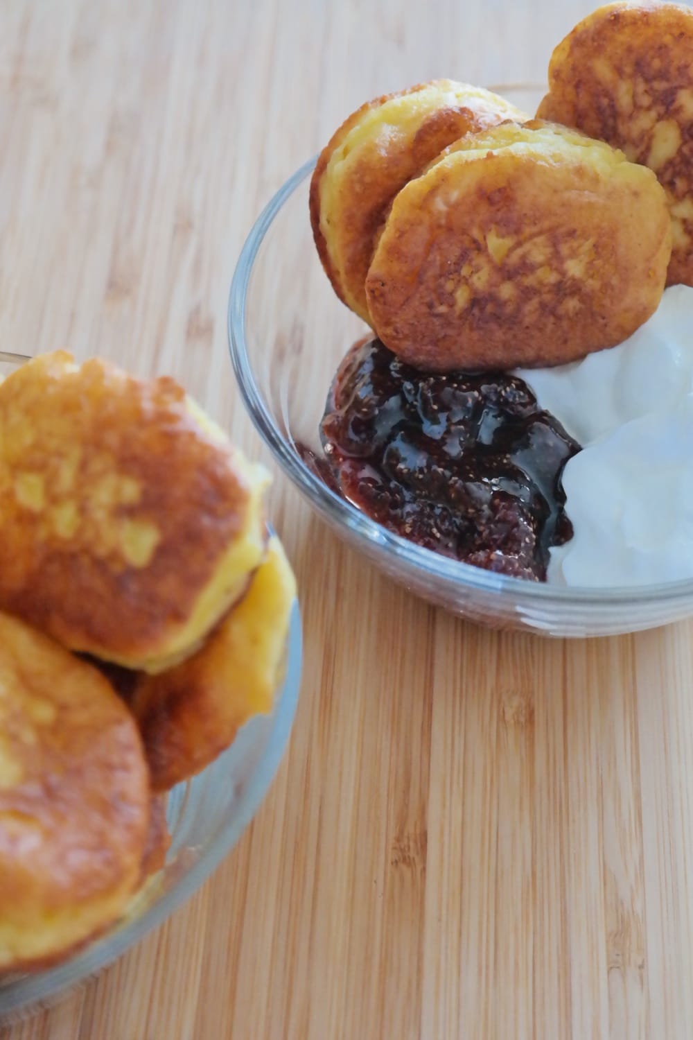 Mini ricotta doughnuts served with sour cream and strawberry jam
