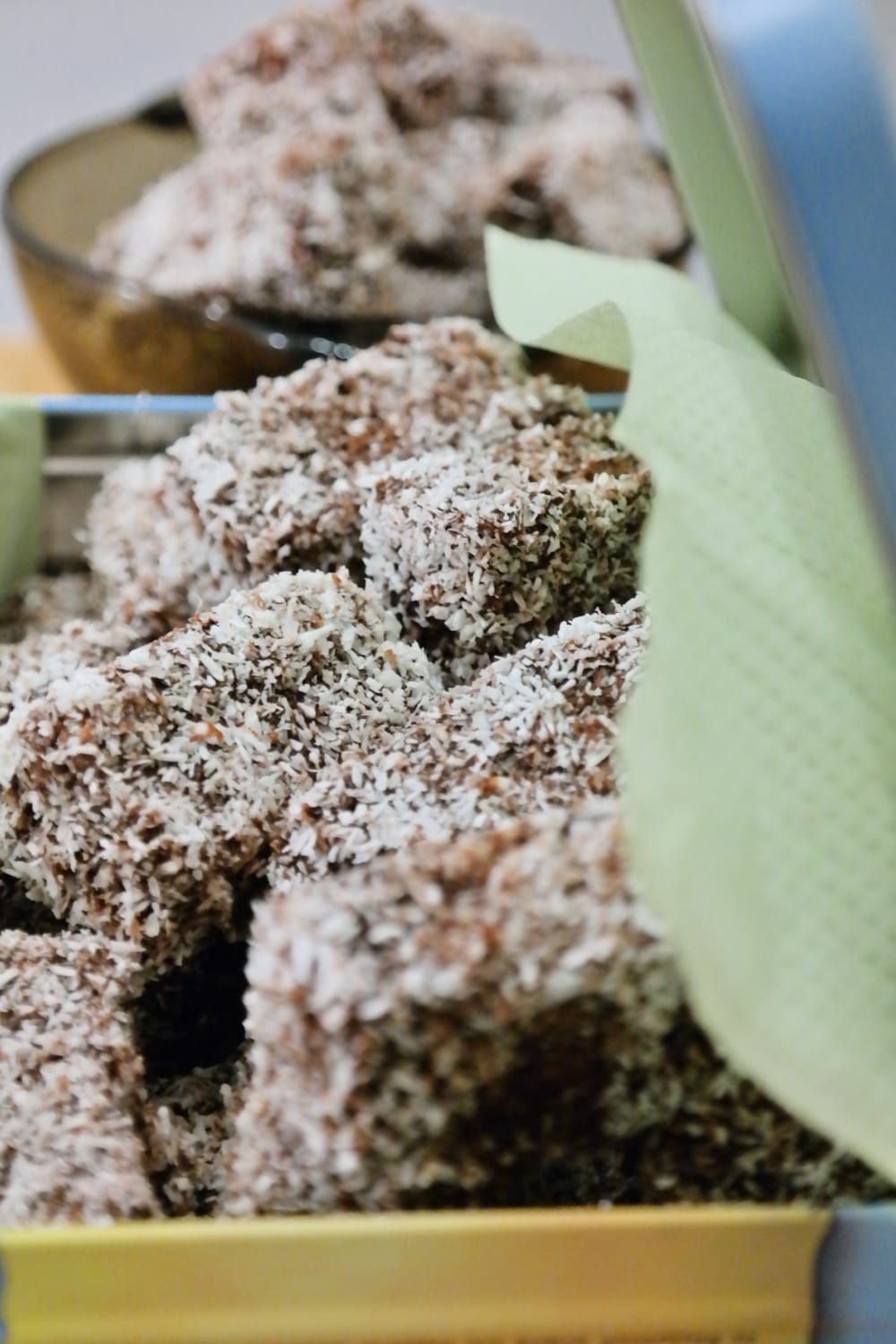 Coconut Lamington cake pieces coated with chocolate glaze and shredded coconut