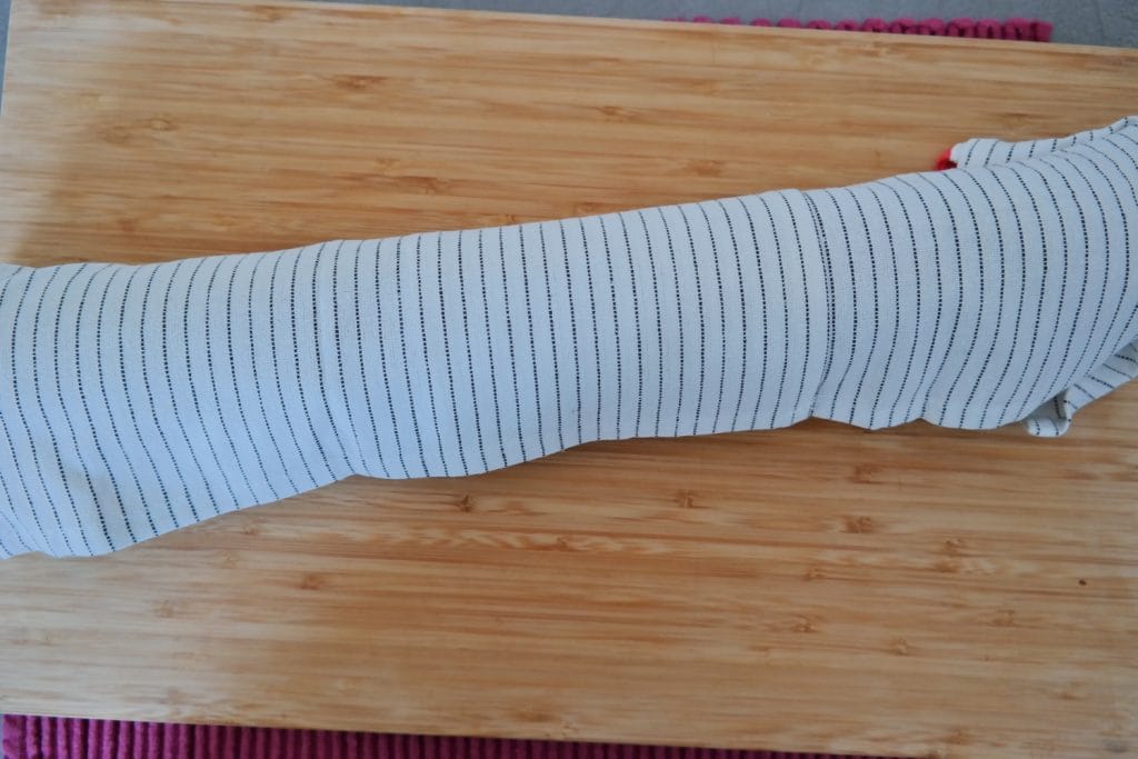 Cocoa sponge cake rolled in a kitchen towel to help it keep its shape