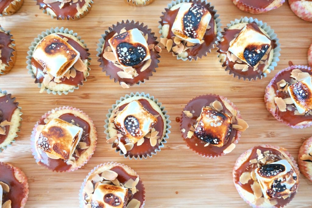 Caramel cupcakes topped with sliced almonds and toasted marshmallows