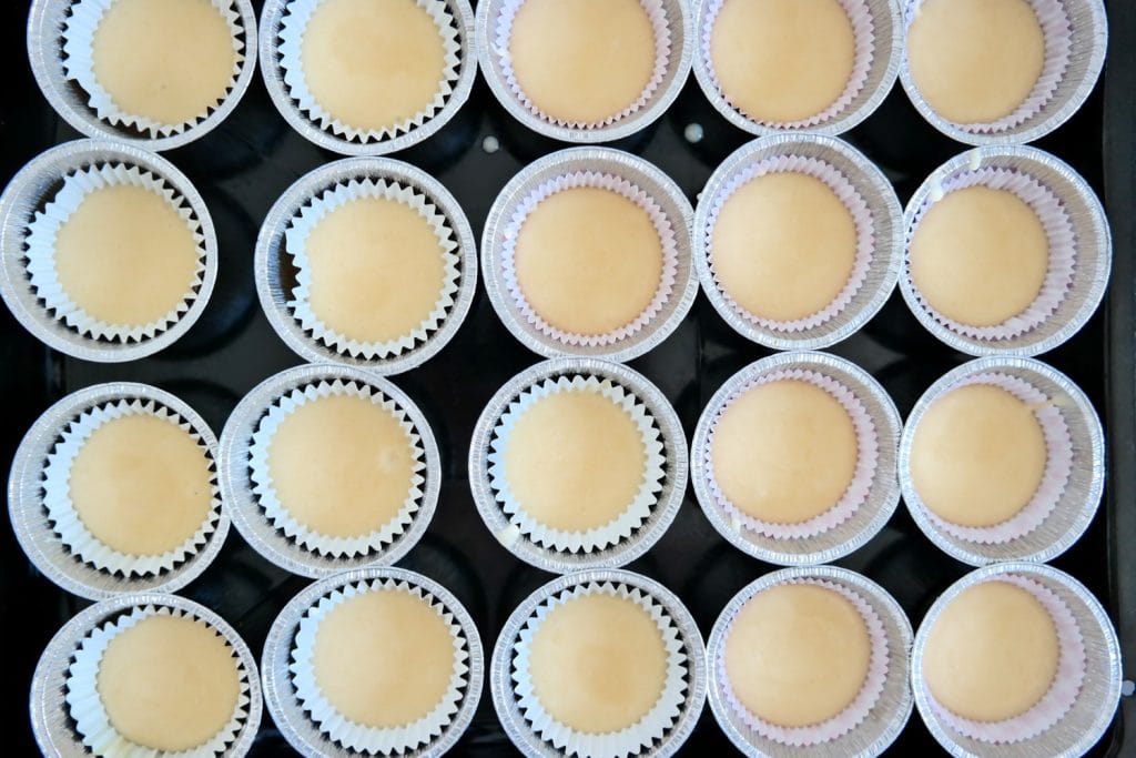 Cupcake batter portioned into individual liners and ready for baking