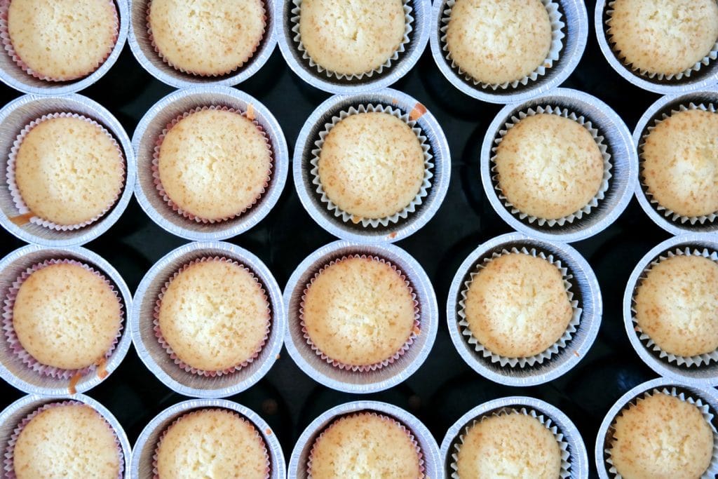 Fluffy golden cupcakes fresh from the oven, ready to be filled with caramel