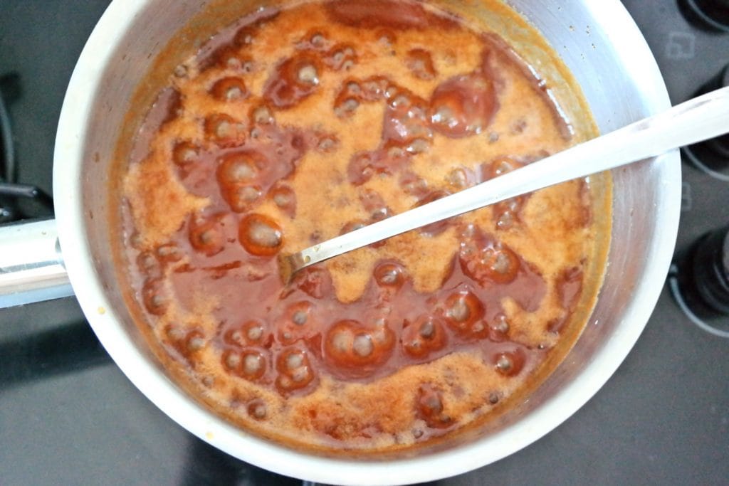 Homemade caramel sauce cooking in a saucepan for filling the cupcakes