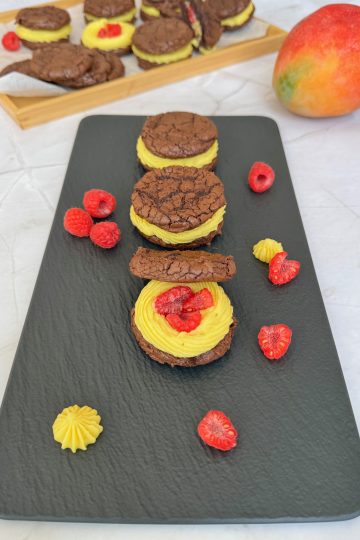 Brownie sandwich cookies with mango ganache