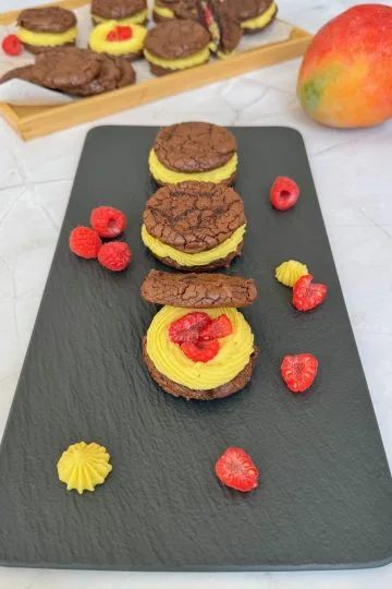 Brownie sandwich cookies with mango ganache