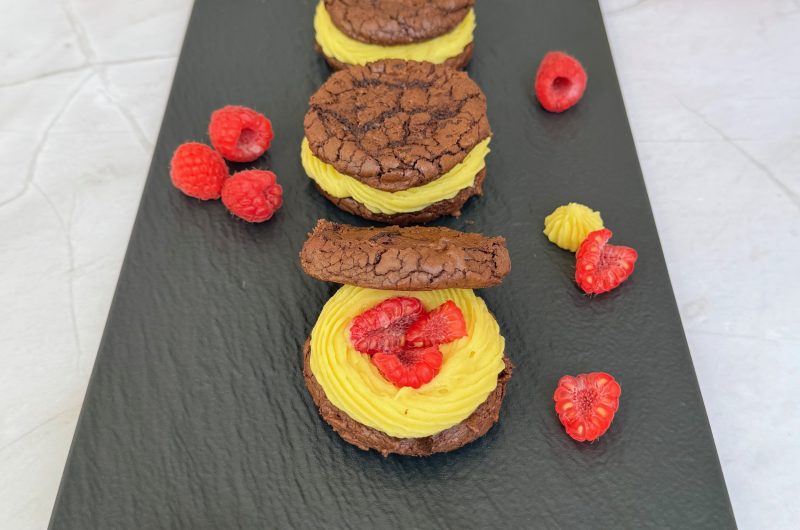 Brownie Sandwich Cookies with Mango Ganache and Raspberry