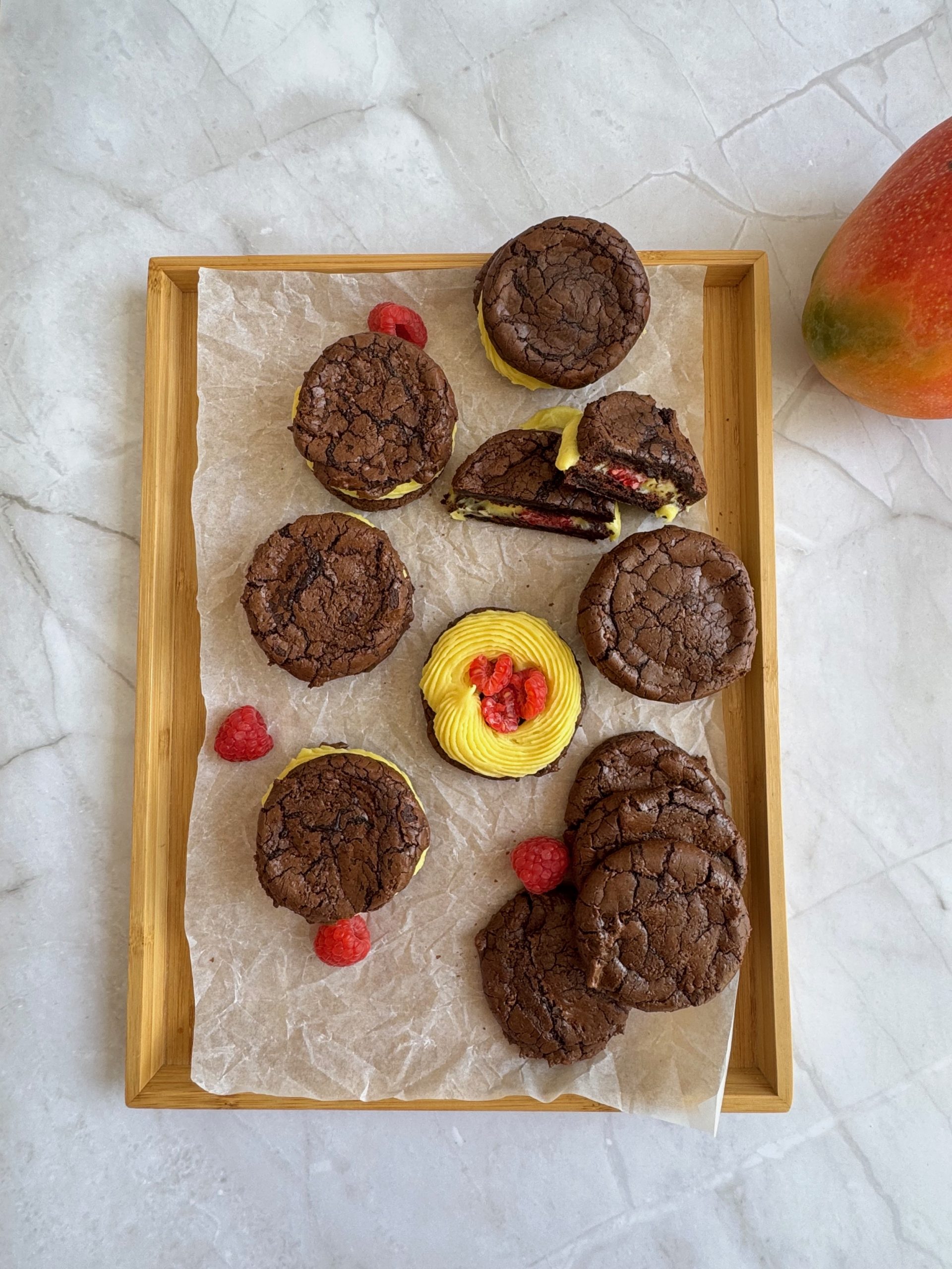 Cookies stuffed with raspberry and mango ganache