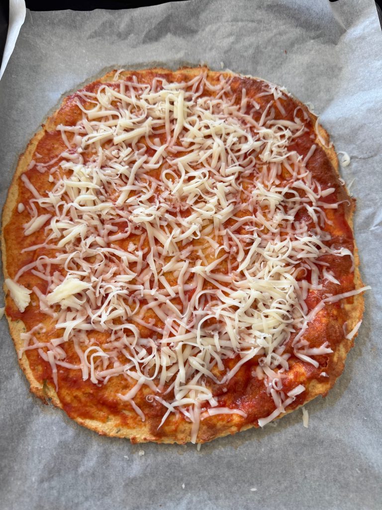 Pizza with tomato sauce and cheese toppings before baking