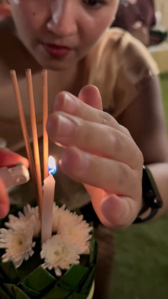 Lighting the flower krathong for the Loy Krathong festival, Phuket, Thailand