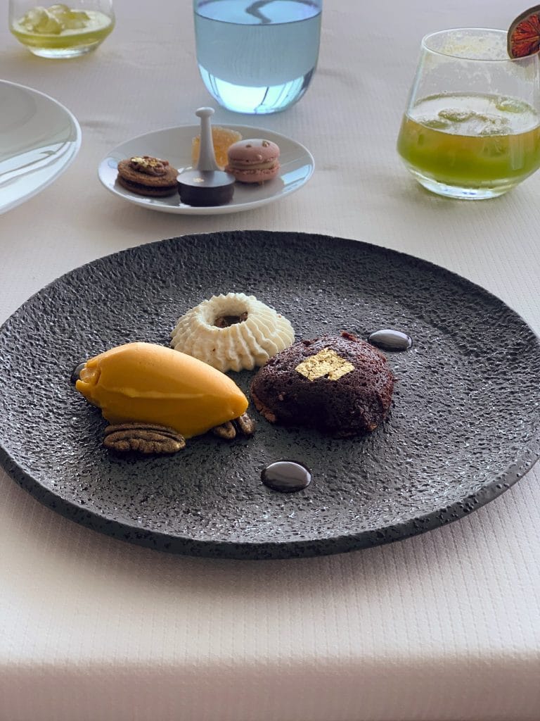Prim-plan cu un desert de lux servit pe o farfurie neagra, intr-un cadru de fine dining din Dubai