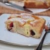 A close-up of a slice of apricot, plum and ricotta cake served on a plate