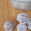 Date energy balls with peanut butter and chocolate, coated in shredded coconut