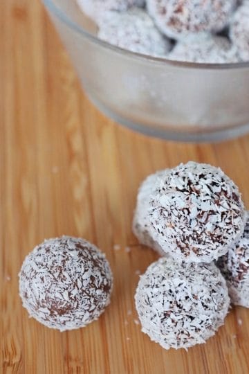 Date energy balls with peanut butter and chocolate, coated in shredded coconut