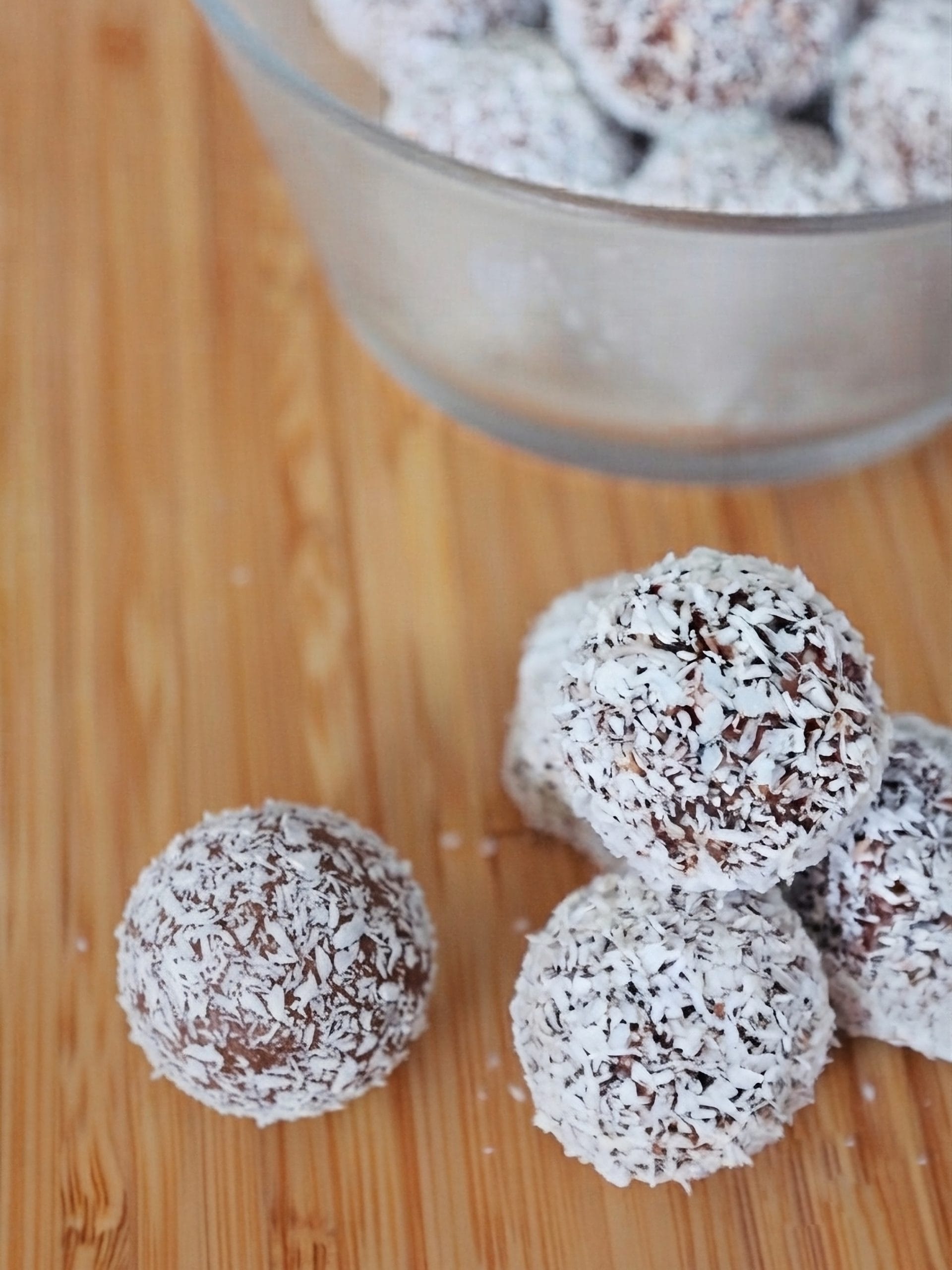 Date energy balls with peanut butter and chocolate, coated in shredded coconut
