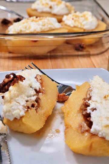 Baked quince with ricotta, honey and walnuts served on a plate