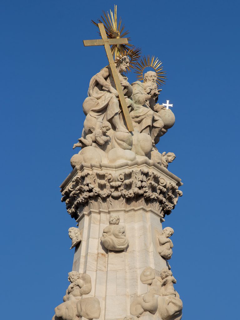 Stone figures and a golden cross at the top of Budapest’s Holy Trinity Column