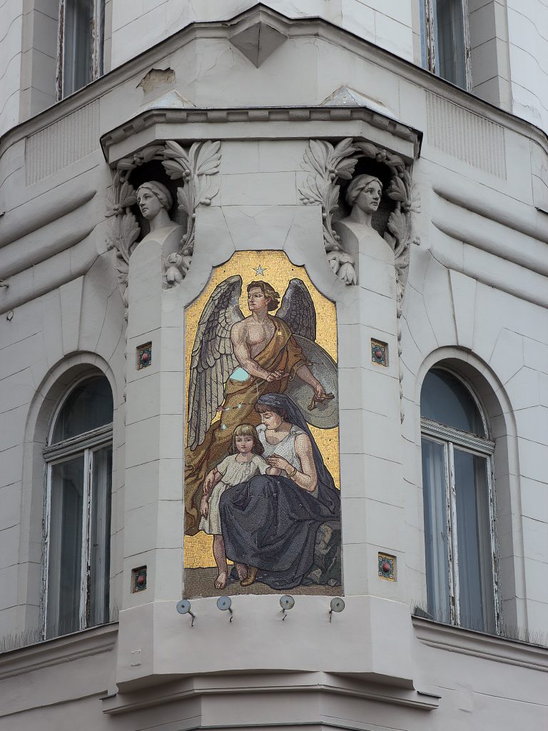 An image of the Madonna and Child on a gold background at the corner of a building