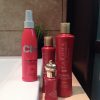 CHI Royal Treatment shampoo, hair mask and Pearl Complex hair oil, alongside 44 Iron Guard spray, arranged beside a bathtub