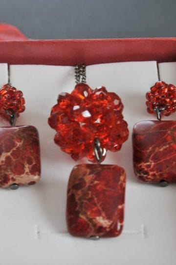Handmade jewelry set in a red gift box, with two earrings and a pendant made of red crystal beads and rectangular red marbled stones